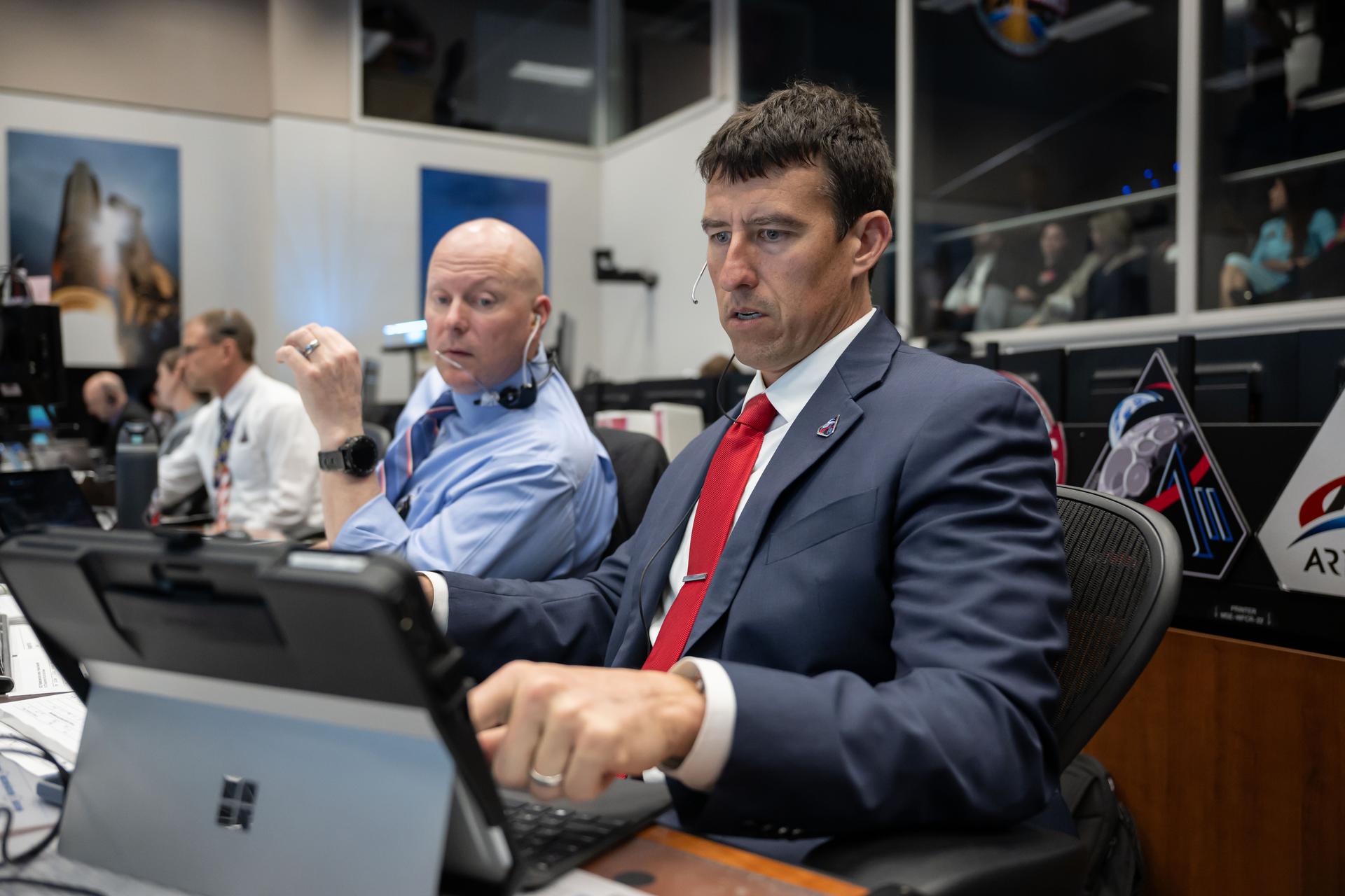 The Artemis II crew share a group hug inside the Orion spacecraft